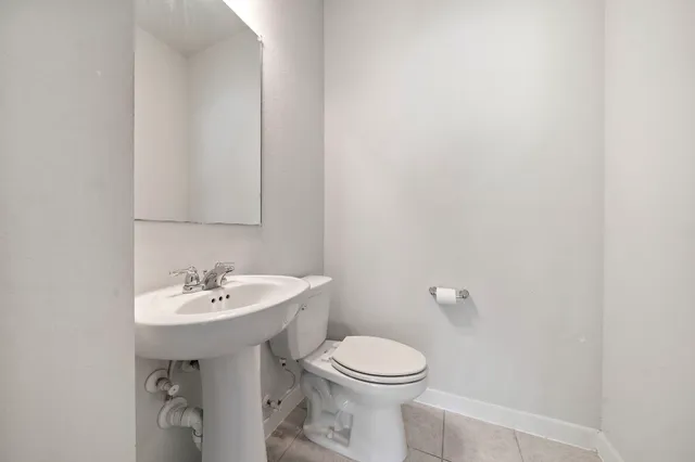 a bathroom with a sink a toilet and mirror