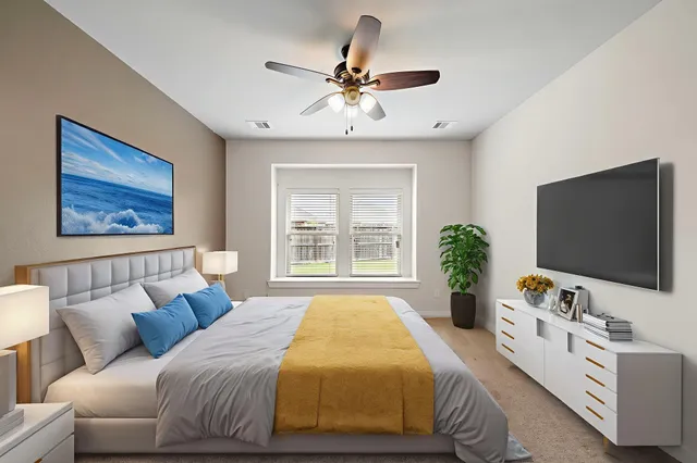 a spacious bedroom with a bed and a flat screen tv