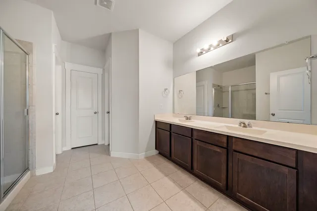 a spacious bathroom with a double vanity sink mirror and
