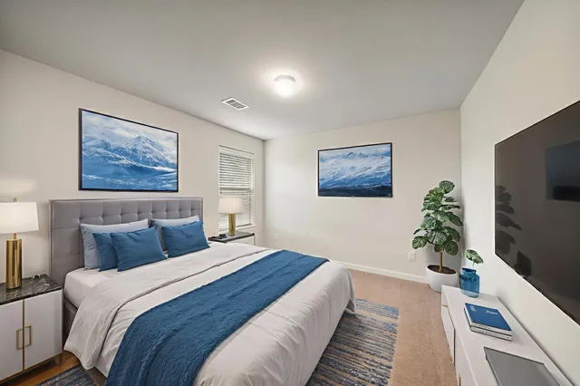 a bedroom with bed and a flat screen tv