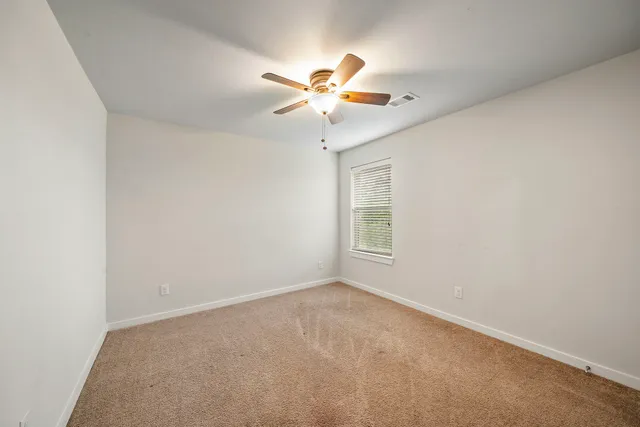 a view of room with window and ceiling fan