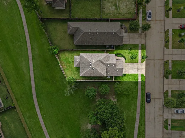 an aerial view of a house with a yard