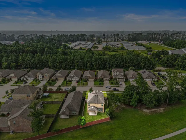 an aerial view of a house with a yard