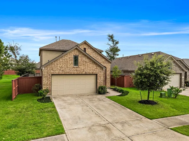 a front view of a house with a garden and plants