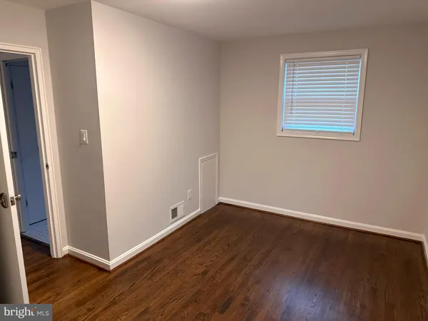 a view of a room with wooden floor and window