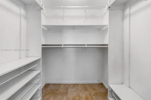 a bathroom with a granite countertop sink a toilet a mirror and bathtub