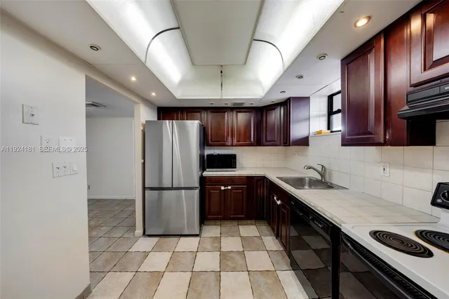 a view of an empty room with a kitchen