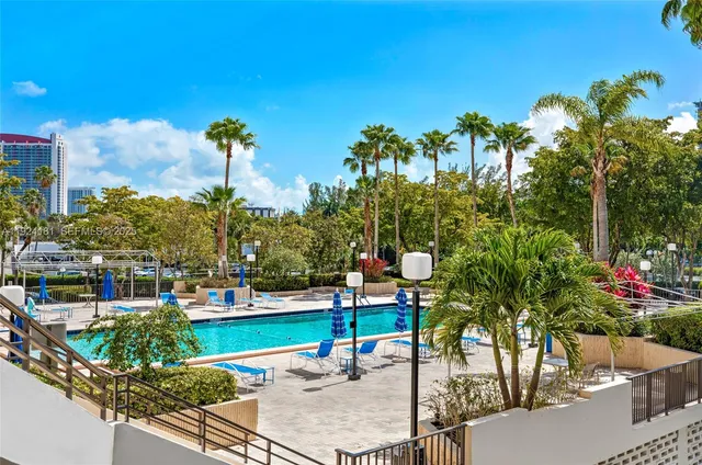 a view of a swimming pool with sitting area