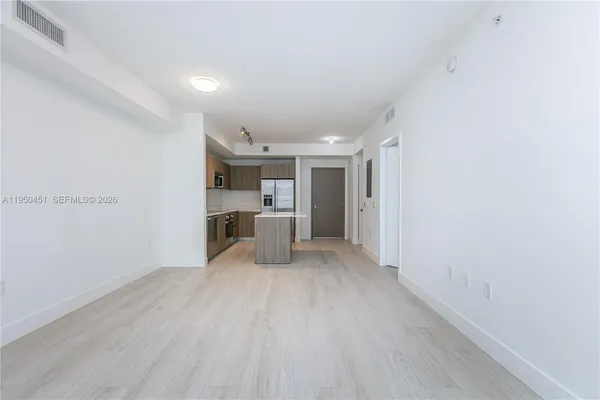 a view of a kitchen with a sink and cabinets
