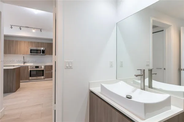 a kitchen with a sink stove and microwave