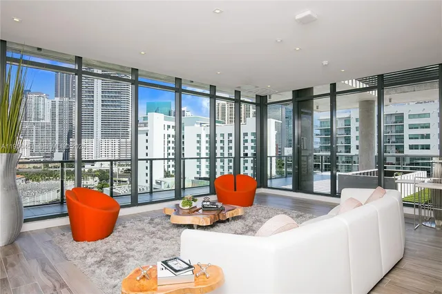 a living room with furniture pool table and a large window