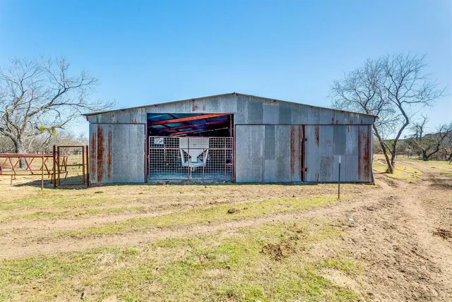 a view of wooden house with a yard