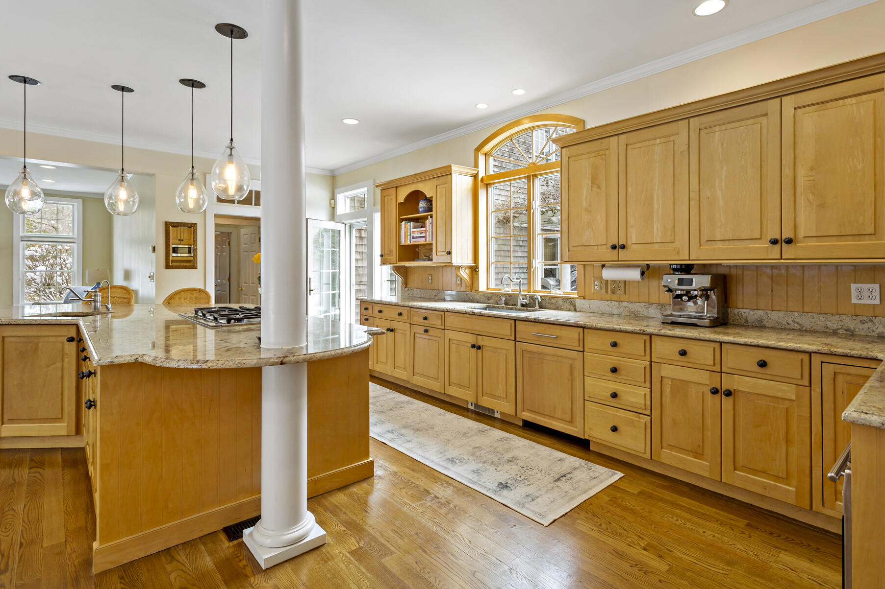 442 Bay Lane Centerville, MA 02632 - Photo 16 of 36 a large kitchen with kitchen island granite countertop a large window cabinets and stainless steel appliances