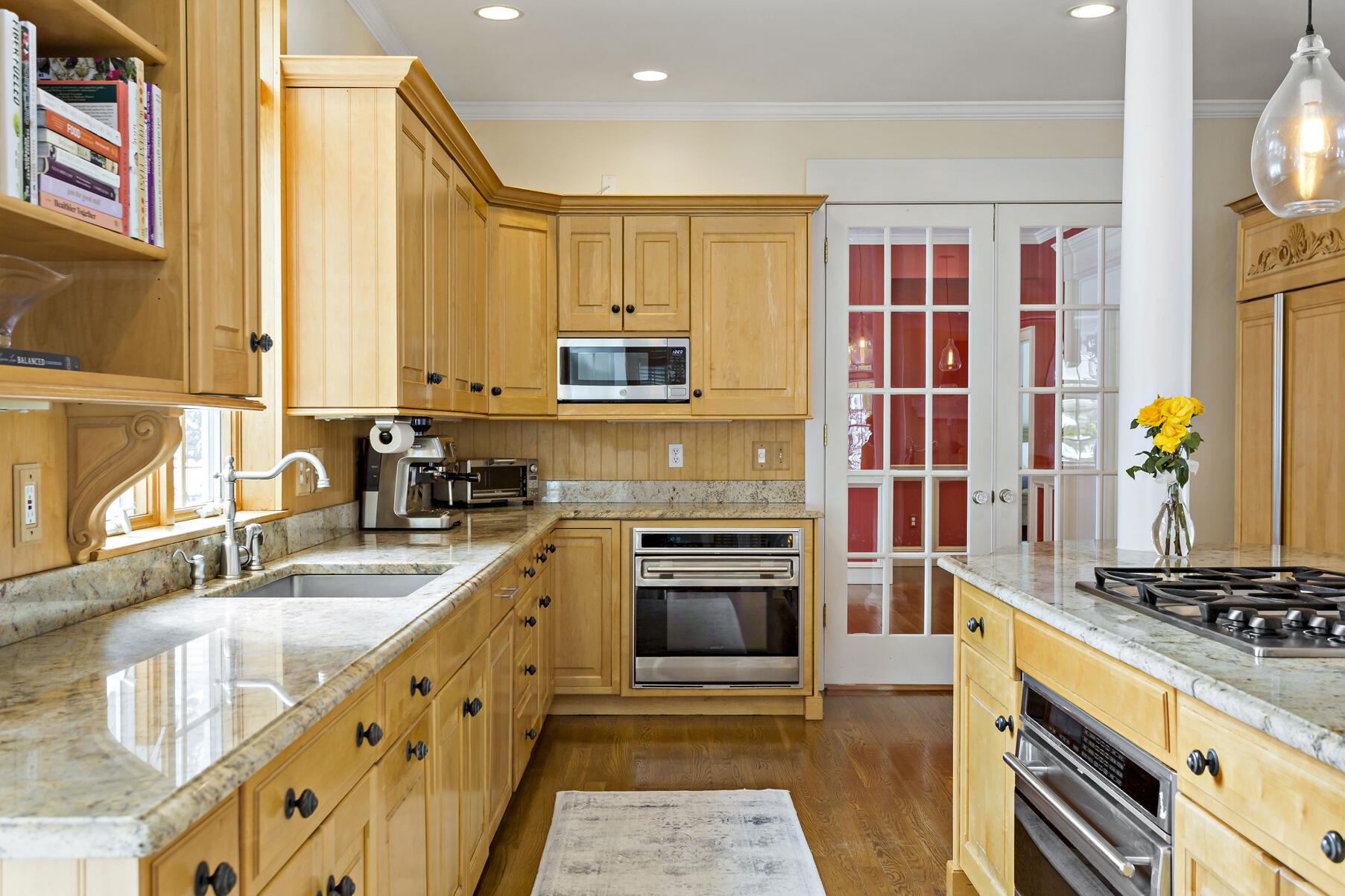 442 Bay Lane Centerville, MA 02632 - Photo 18 of 36 a kitchen with stainless steel appliances granite countertop a stove a sink and a microwave
