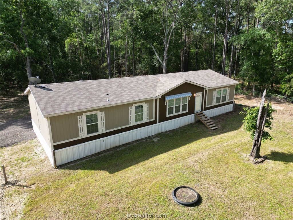 a aerial view of a house with pool table and chairs