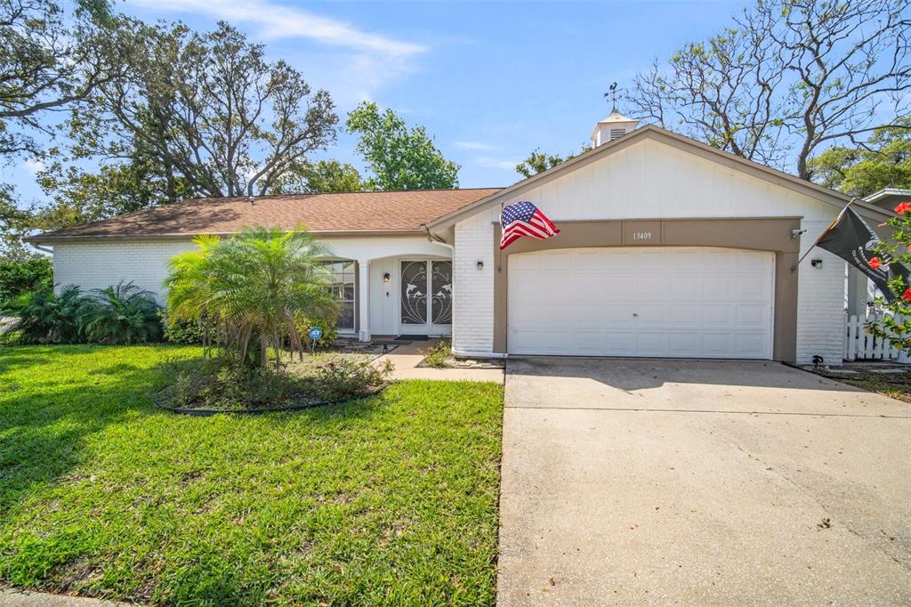 13409 Rayburn Road Hudson, FL 34667 - Photo 1 of 1 a front view of house with yard
