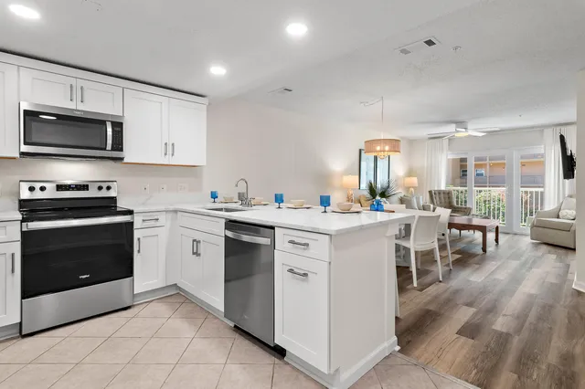 a kitchen with a sink cabinets and wooden floor