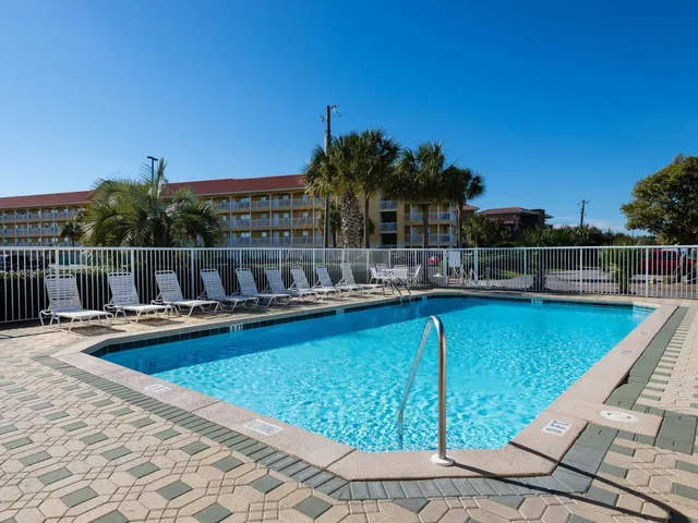 a view of swimming pool with outdoor seating and yard in the back