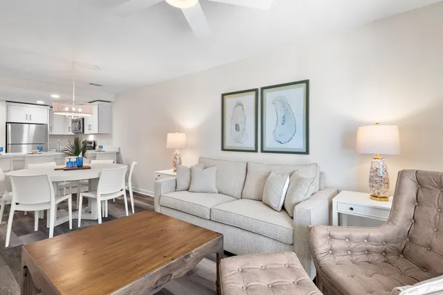 a living room with furniture a rug and a lamp