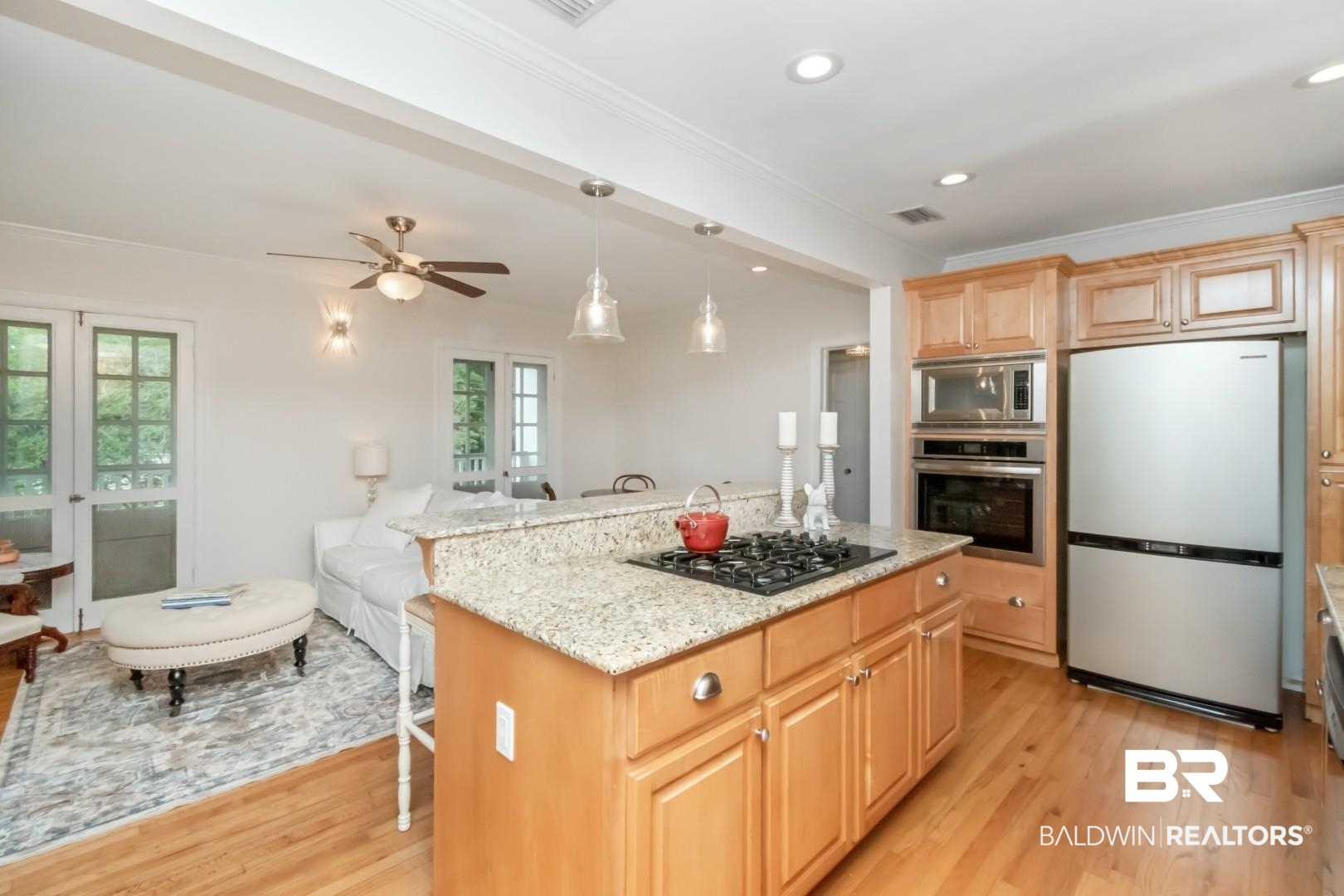 214 Upham Street, Unit 3D Mobile, AL 36607 - Photo 14 of 34 Kitchen featuring stainless steel appliances, light stone countertops, pendant lighting, light wood-style floors, and ornamental molding