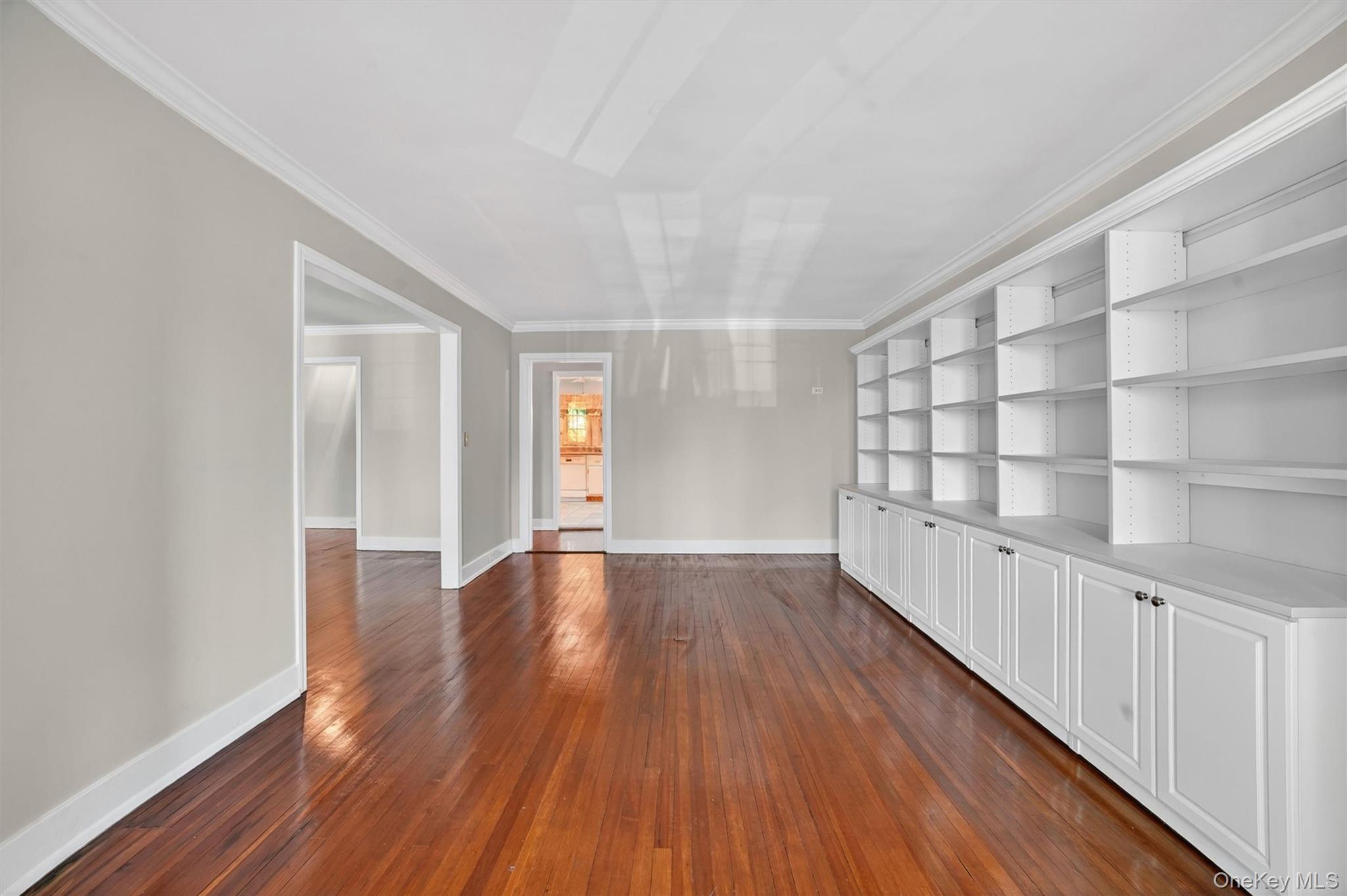 15 Beechtree Lane, Unit 1D Bronxville, NY 10708 - Photo 20 of 41 Large formal dining room with high ceiling and an additional wall of bookcases.