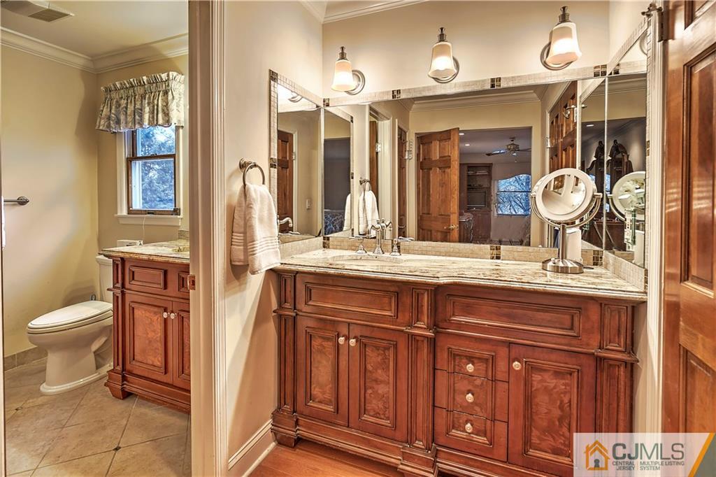 23 Winterberry Circle Piscataway, NJ 08854 - Photo 15 of 29 a bathroom with a granite countertop sink a toilet and a mirror