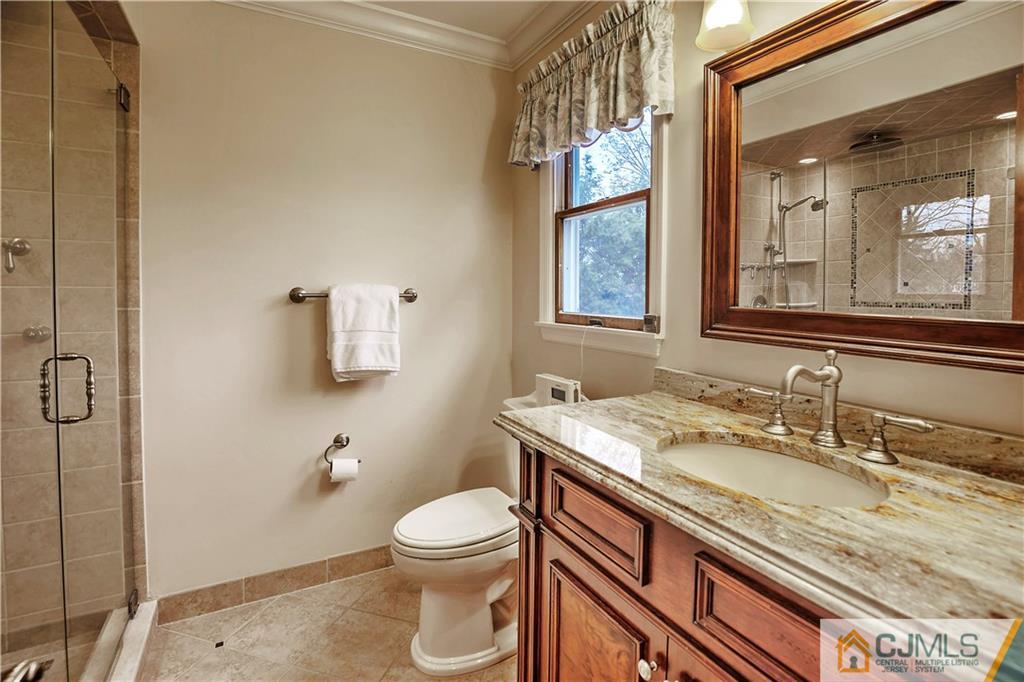 23 Winterberry Circle Piscataway, NJ 08854 - Photo 16 of 29 a bathroom with a granite countertop sink a toilet and a mirror