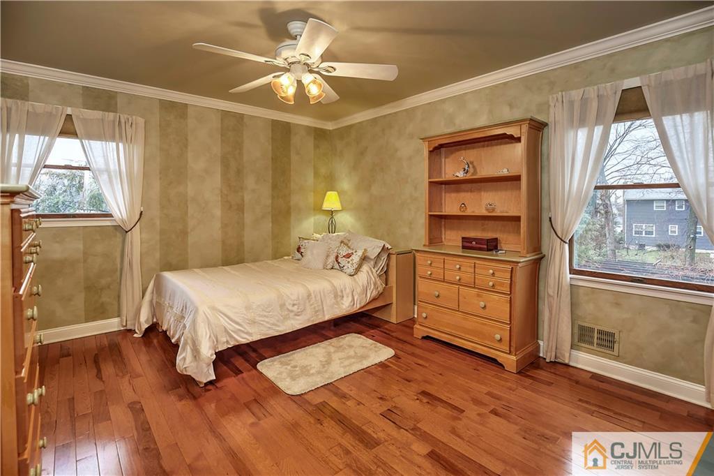 23 Winterberry Circle Piscataway, NJ 08854 - Photo 18 of 29 a bedroom with a bed cabinets and wooden floor