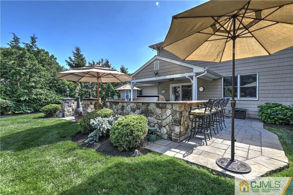 23 Winterberry Circle Piscataway, NJ 08854 - Photo 28 of 29 a view of a patio with chairs under an umbrella