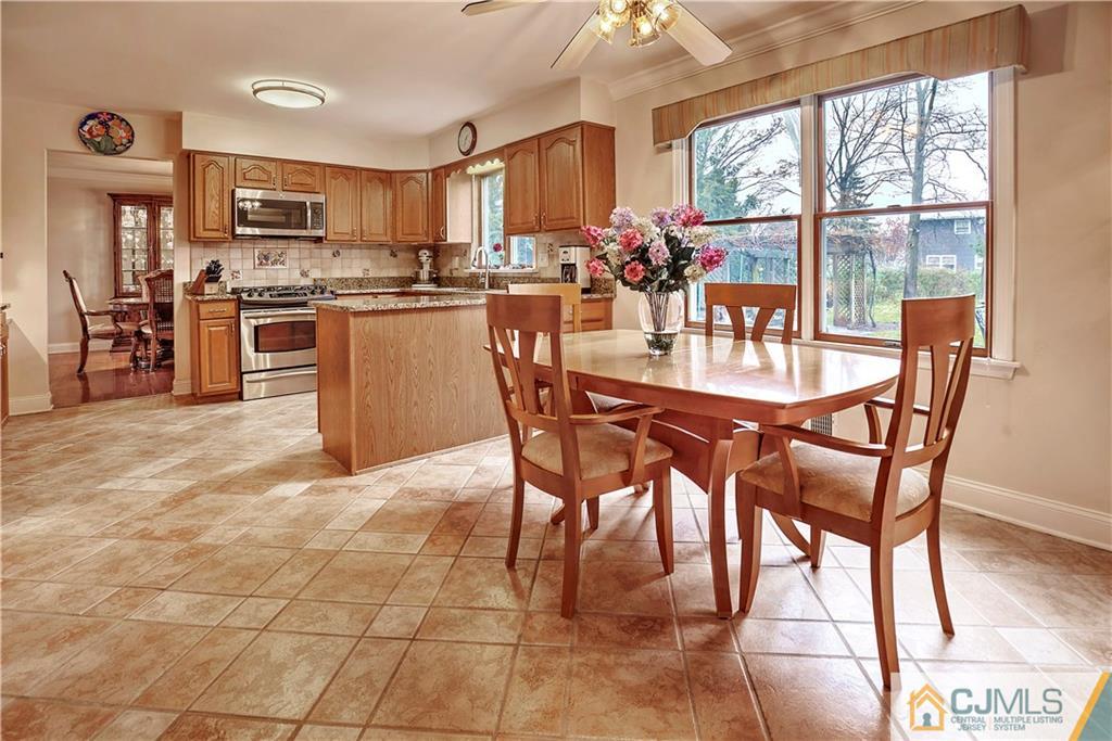 23 Winterberry Circle Piscataway, NJ 08854 - Photo 8 of 29 a dining area with stainless steel appliances a table chairs and a refrigerator