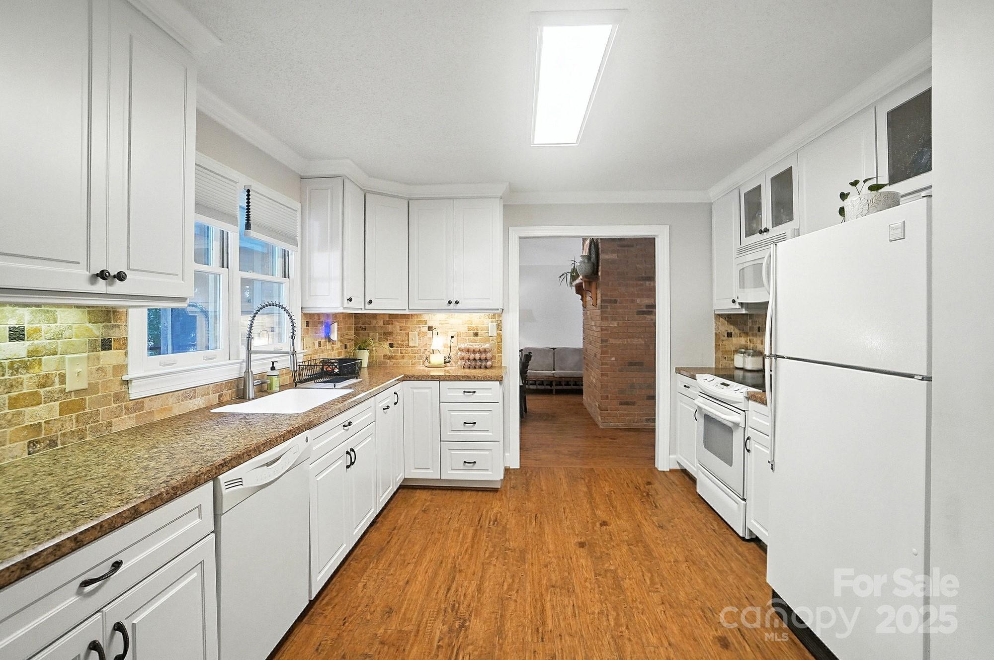 3618 Griffith Road Monroe, NC 28112 - Photo 16 of 48 a kitchen with stainless steel appliances a refrigerator sink and cabinets