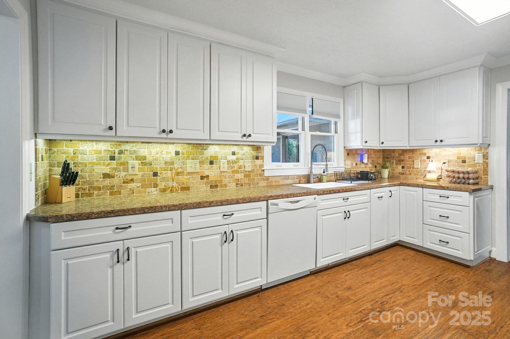 3618 Griffith Road Monroe, NC 28112 - Photo 17 of 48 a kitchen with granite countertop white cabinets and white stainless steel appliances