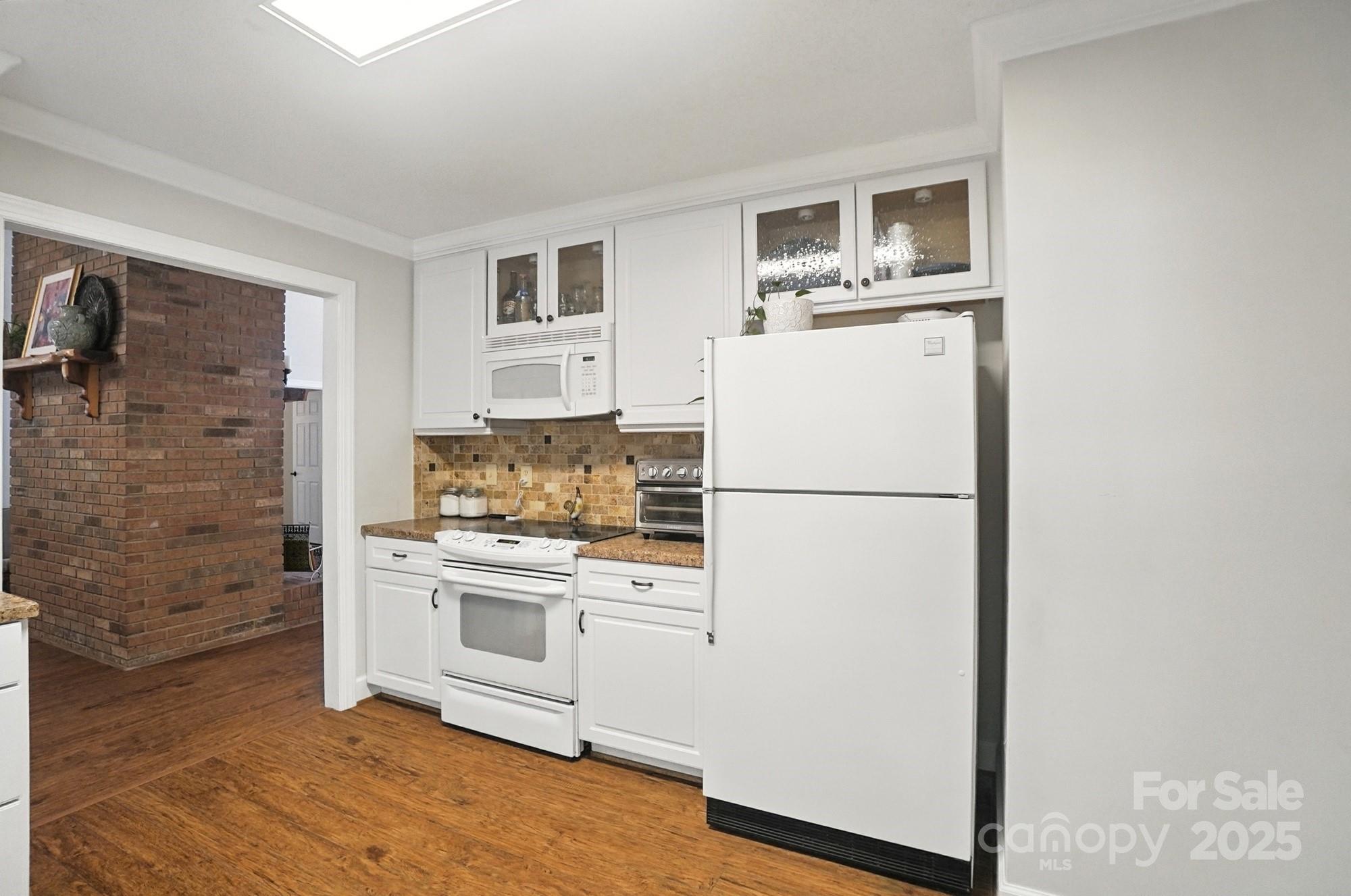 3618 Griffith Road Monroe, NC 28112 - Photo 18 of 48 a white refrigerator freezer and a stove sitting inside of a kitchen