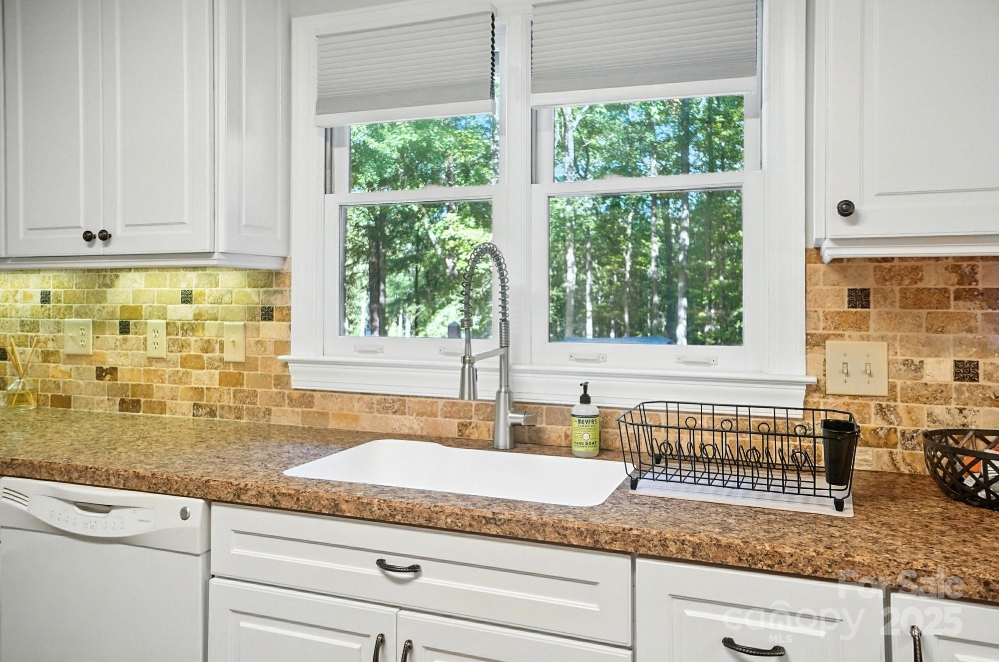 3618 Griffith Road Monroe, NC 28112 - Photo 19 of 48 a kitchen with granite countertop a sink and a window