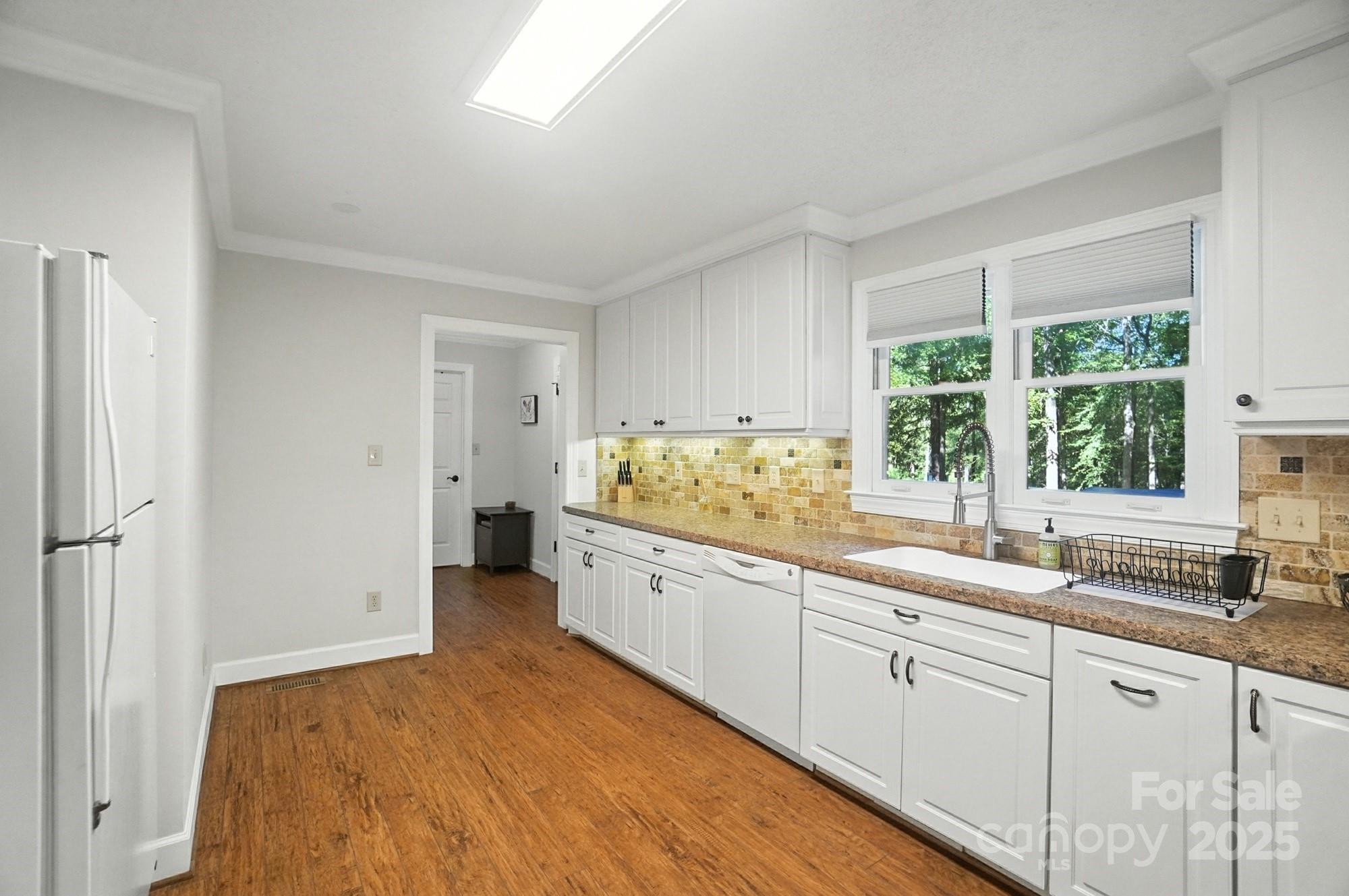 3618 Griffith Road Monroe, NC 28112 - Photo 20 of 48 a large white kitchen with a sink window and cabinets
