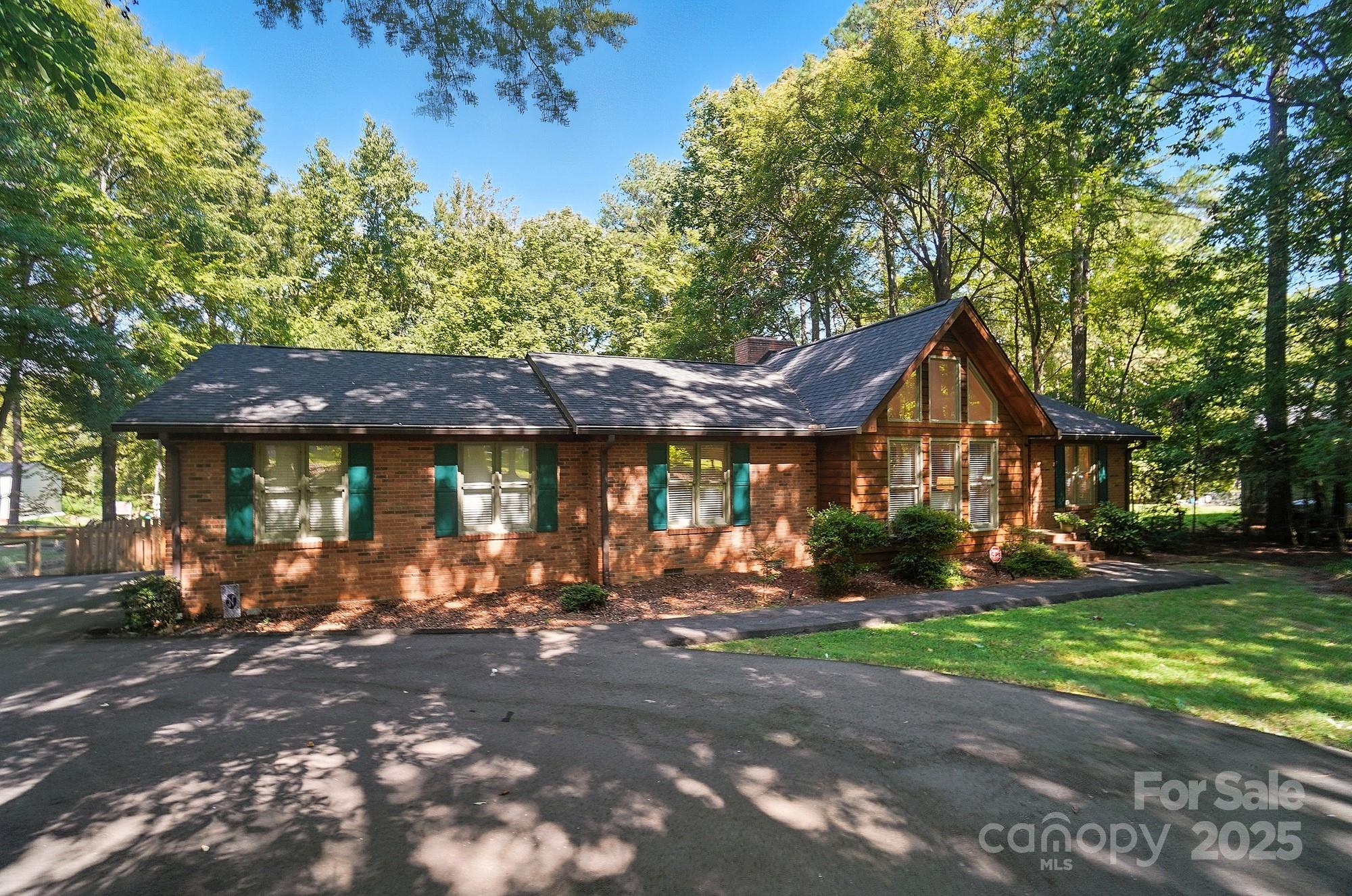 3618 Griffith Road Monroe, NC 28112 - Photo 2 of 48 a view of a town with brick building and large trees