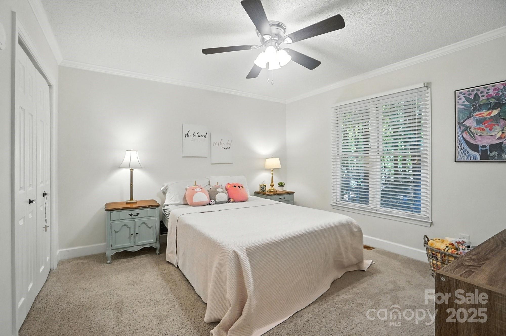 3618 Griffith Road Monroe, NC 28112 - Photo 24 of 48 a bedroom with a bed and a chandelier
