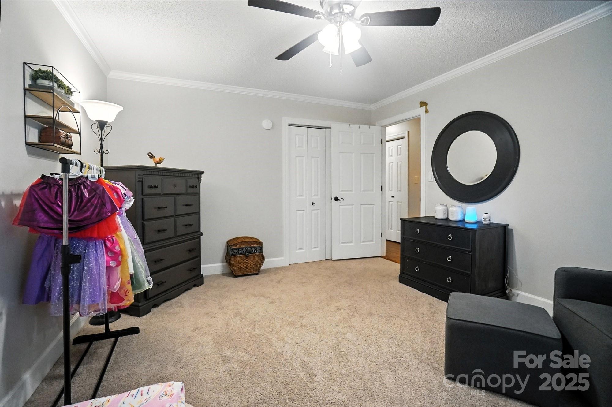 3618 Griffith Road Monroe, NC 28112 - Photo 28 of 48 a bedroom with a bed and a chandelier
