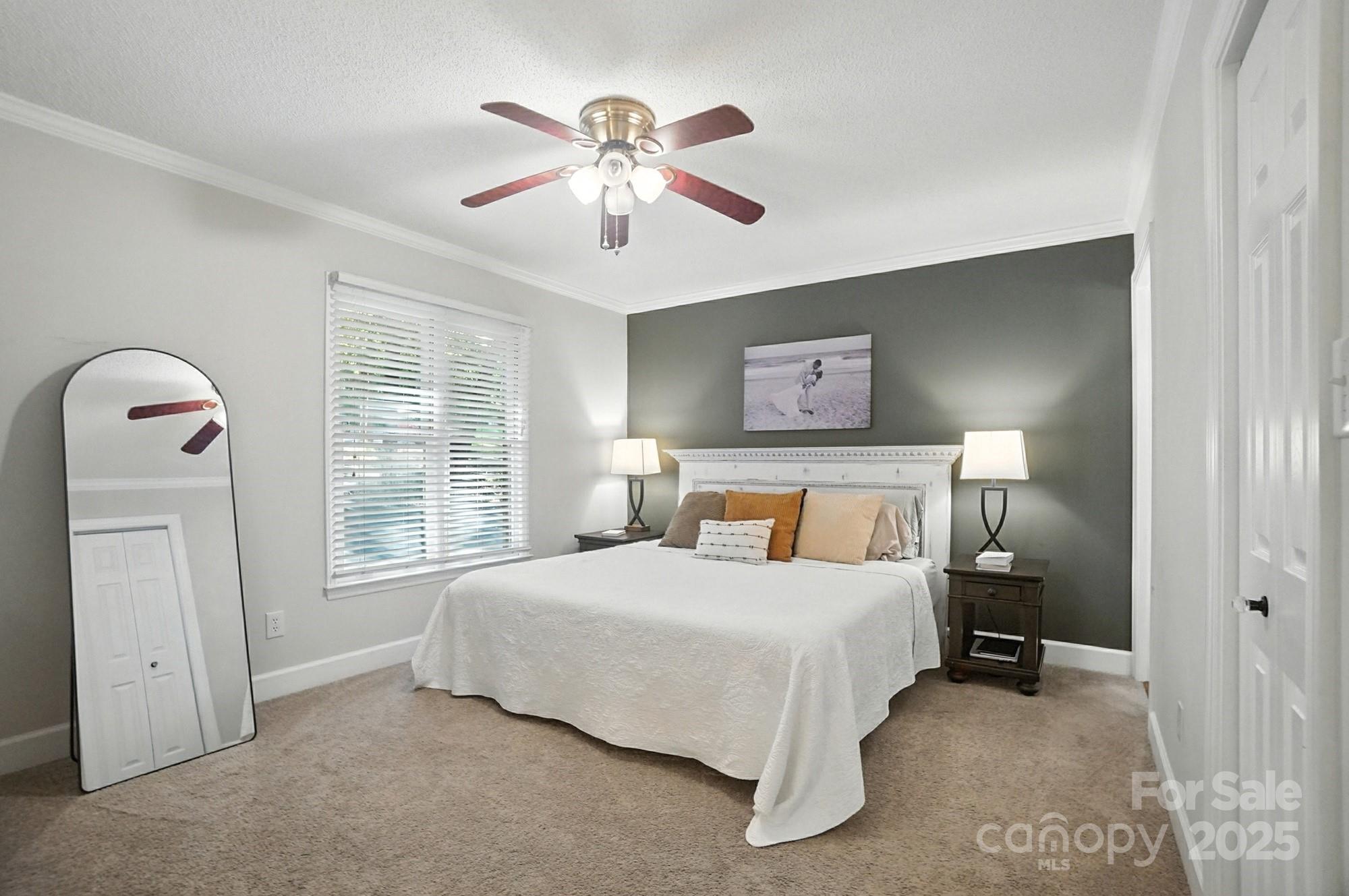 3618 Griffith Road Monroe, NC 28112 - Photo 30 of 48 a bedroom with a bed and a chandelier