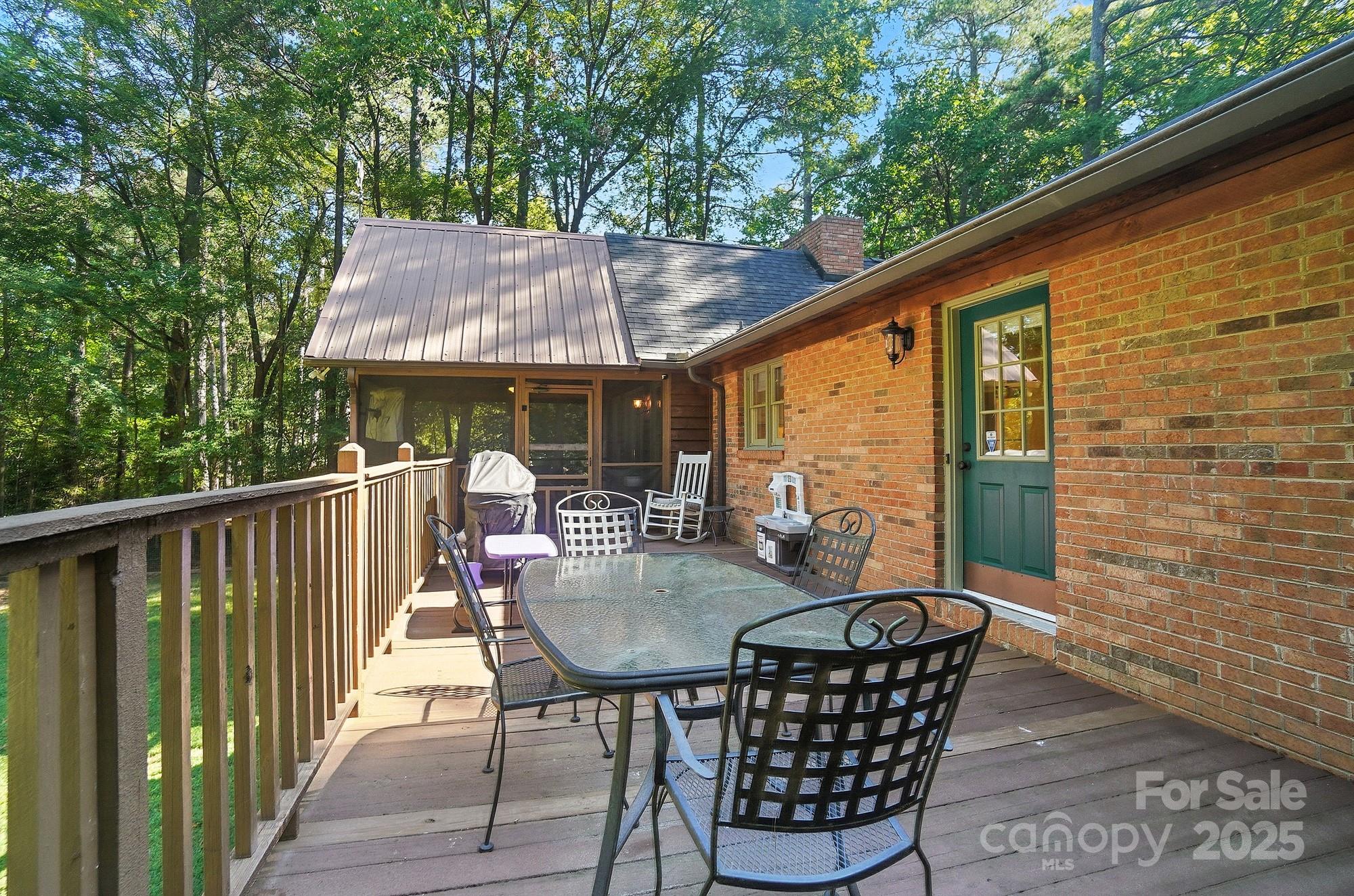 3618 Griffith Road Monroe, NC 28112 - Photo 39 of 48 a patio with wooden floor a yard a table and chairs