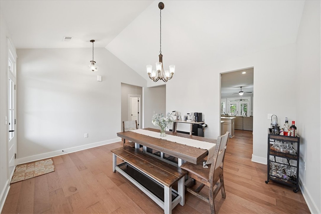 214 Timothy Court Anderson, SC 29621 - Photo 6 of 43 Hardwood floors and vaulted ceilings elevate this open-concept dining area.