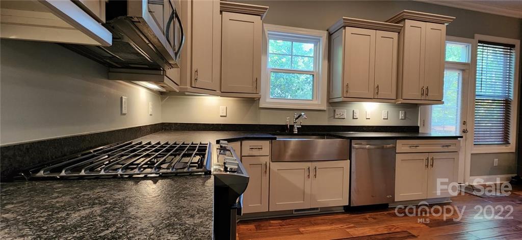 3068 Point Clear Drive Tega Cay, SC 29708 - Photo 7 of 31 a kitchen with granite countertop a stove a sink and a microwave
