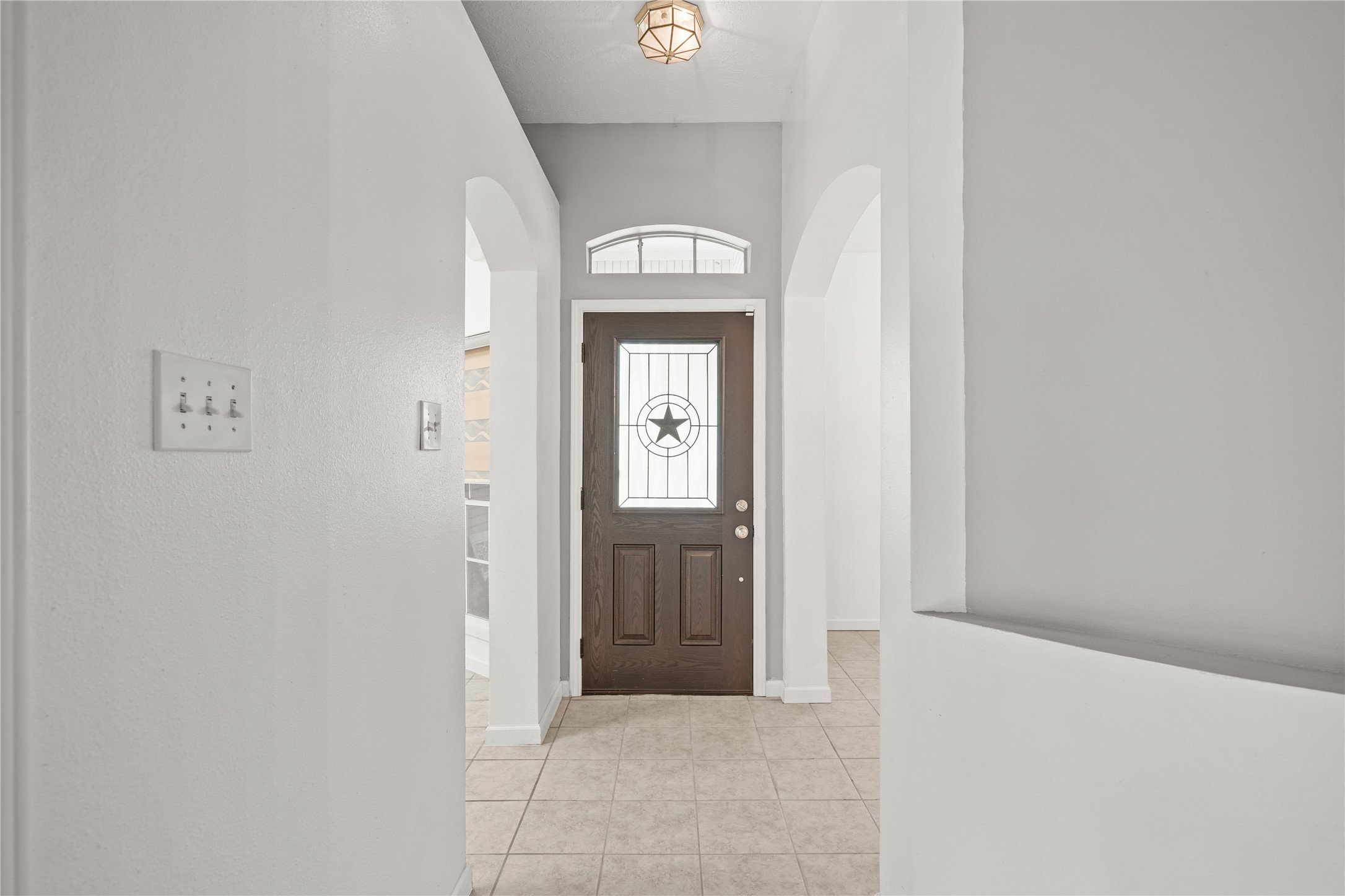 8134 Blue Jay Street Baytown, TX 77523 - Photo 7 of 31 A custom-designed front door sets the tone upon entry, showcasing a Texas star accent that adds distinctive character and a refined rustic touch.
