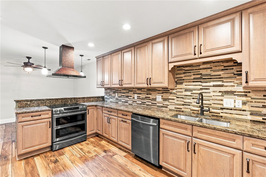 320 Watson Road Easley, SC 29642 - Photo 35 of 50 Gleaming hardwood floors and stone countertops anchor this classic kitchen design.