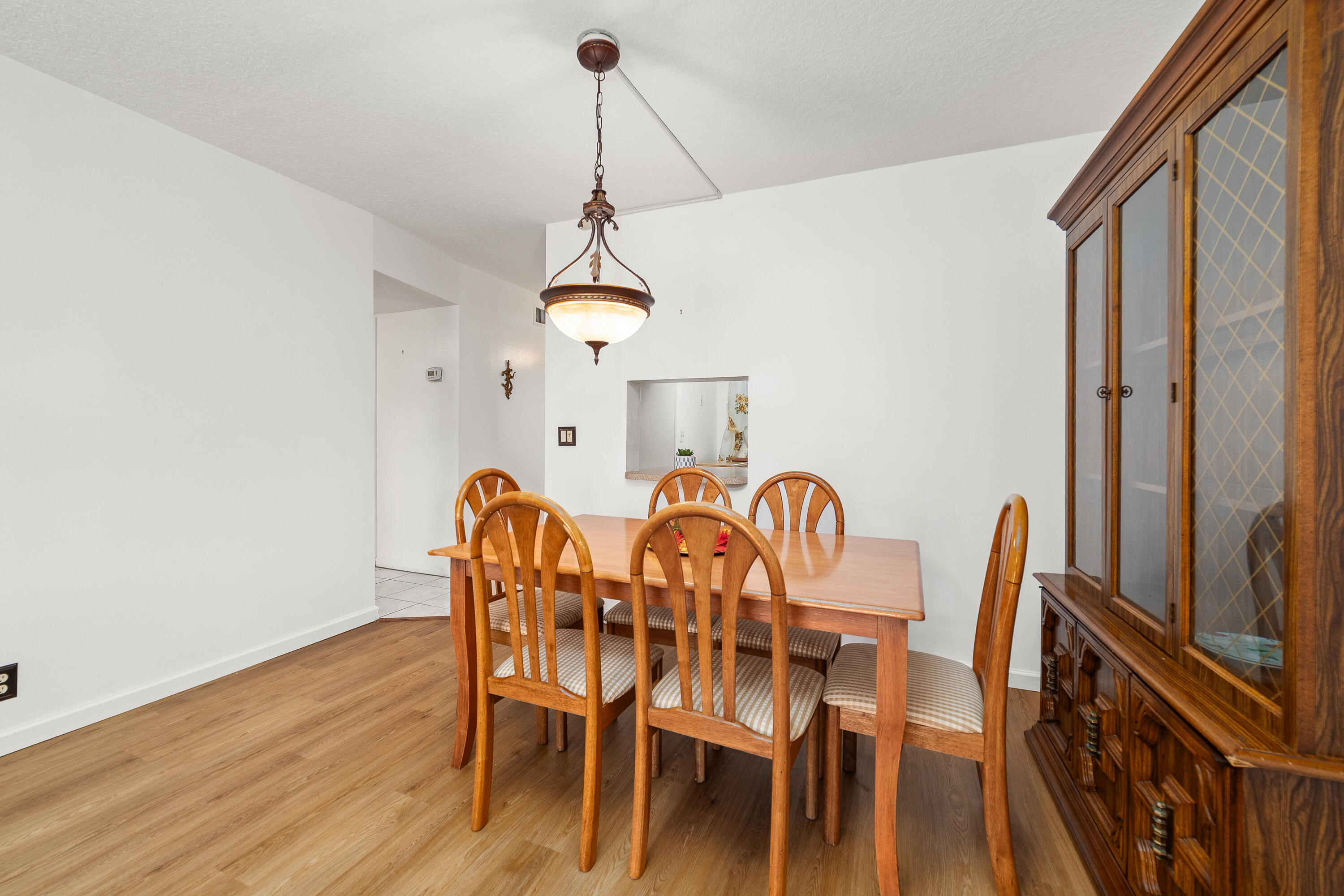 230 Northeast 26th Avenue, Unit 3020 Boynton Beach, FL 33435 - Photo 13 of 44 a view of a dining room with furniture and wooden floor