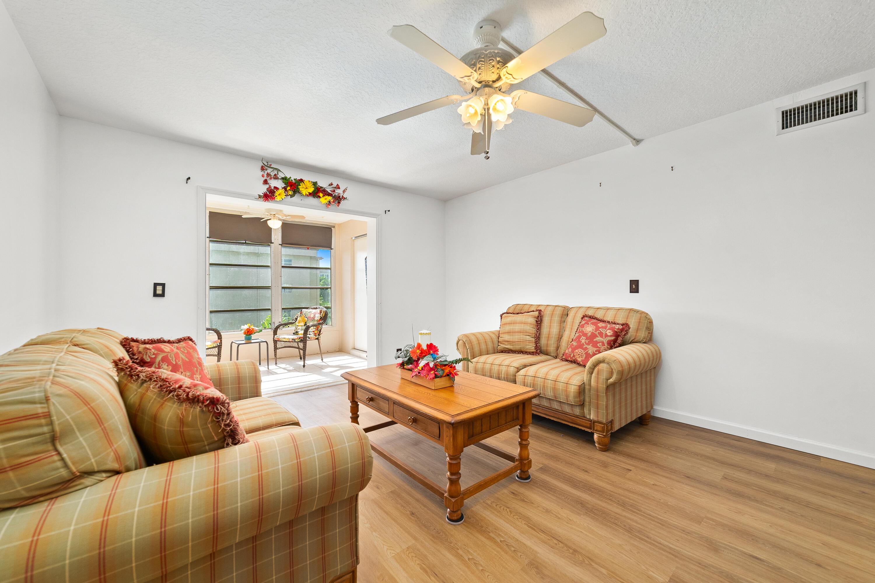 230 Northeast 26th Avenue, Unit 3020 Boynton Beach, FL 33435 - Photo 15 of 44 a living room with furniture and a large window