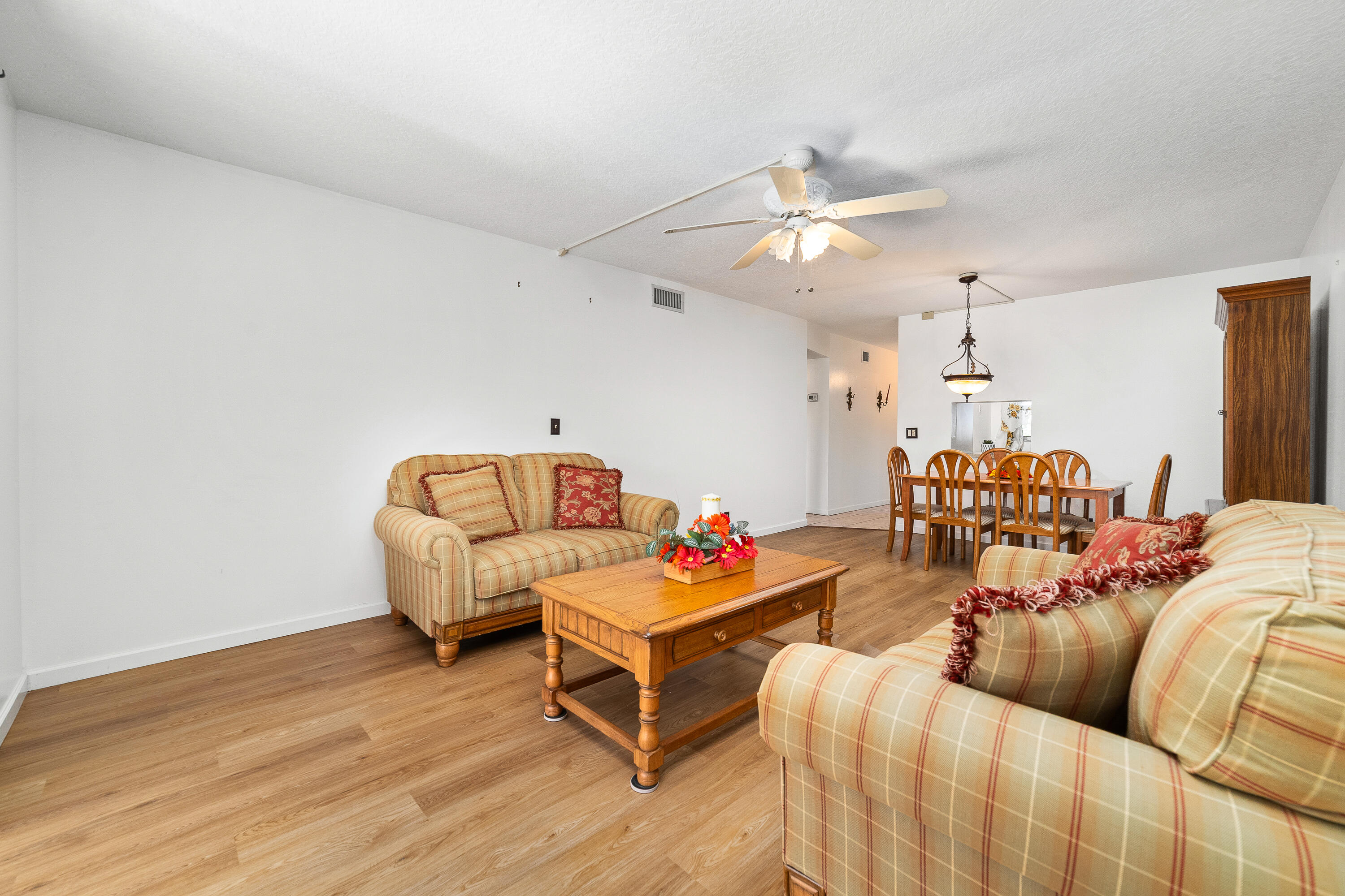 230 Northeast 26th Avenue, Unit 3020 Boynton Beach, FL 33435 - Photo 17 of 44 a living room with furniture and a chandelier