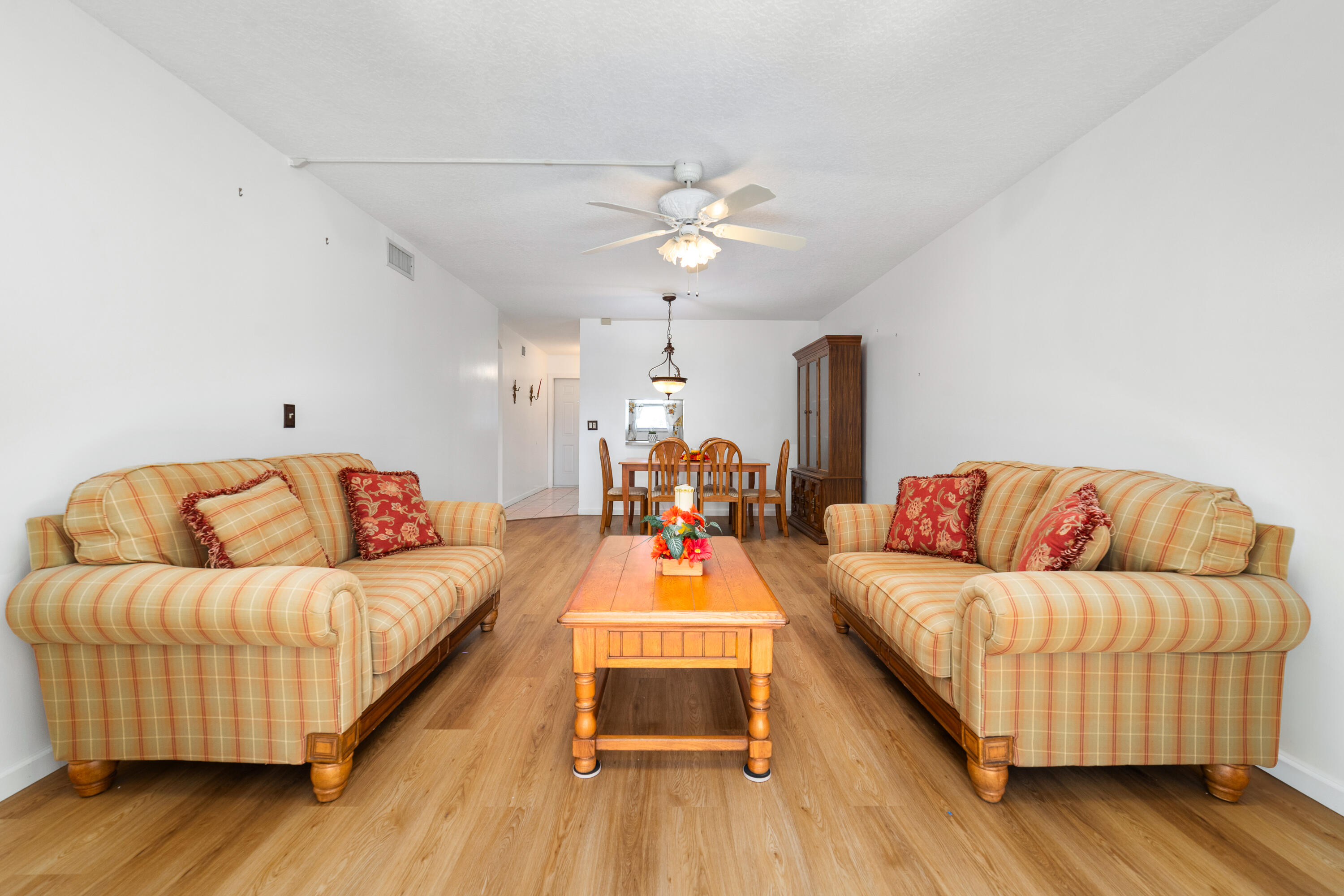 230 Northeast 26th Avenue, Unit 3020 Boynton Beach, FL 33435 - Photo 19 of 44 a living room with furniture and a wooden floor