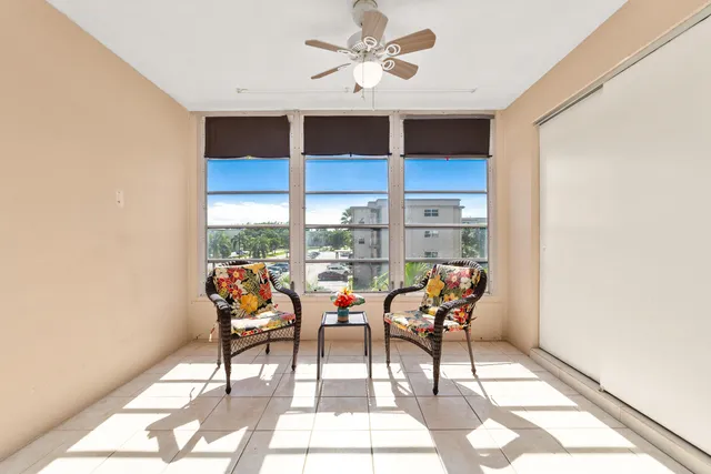 a group of chairs sitting in a living room next to a window
