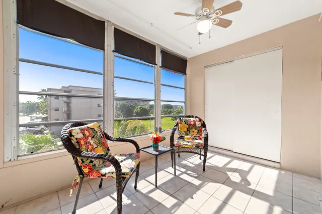 a dining room with furniture and a floor to ceiling window